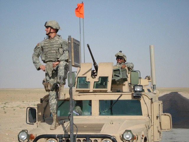 Soldiers on a military vehicle in the desert